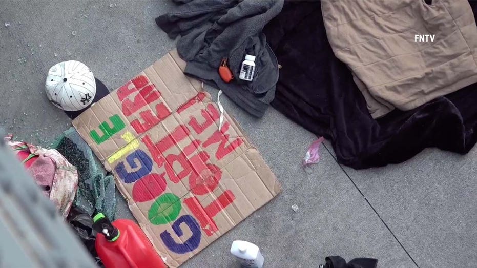 A hand-painted sign reads "Google Tortured Me"