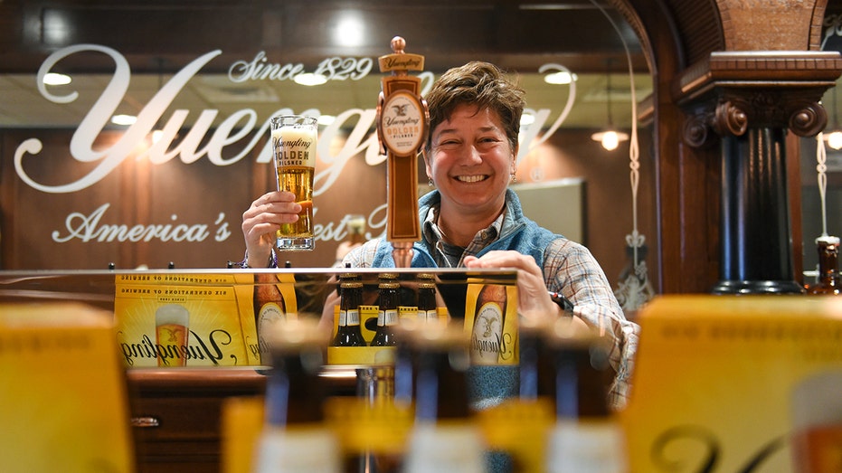 Jennifer Yuengling holds glass of beer