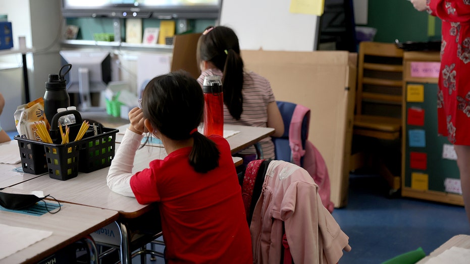 Girl sits in classroom in New York