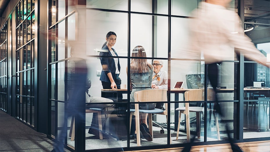 Business persons walking and working around the office building