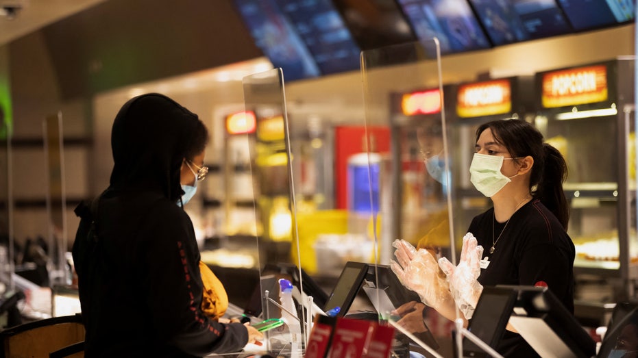 Moviegoer shops at concessions stands at a AMC theatre on reopening day during the outbreak of the coronavirus disease (COVID-19), in Burbank