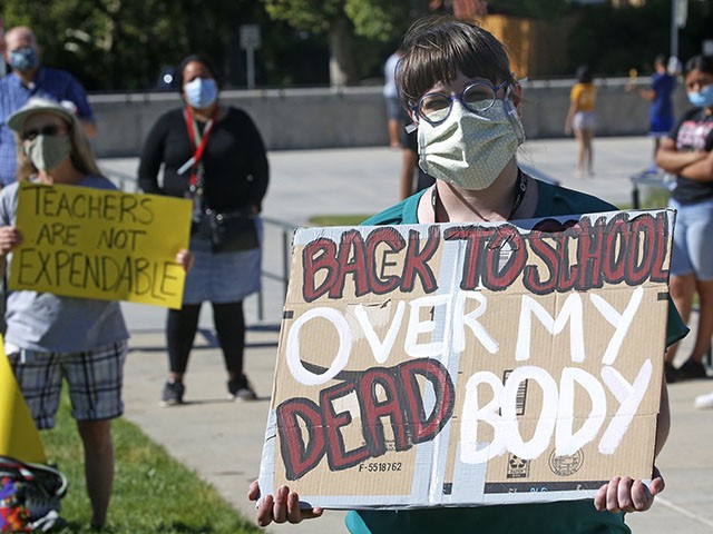 Junior high teacher Angela Andrus attends an Utah Safe Schools Mask-In urging the governor's leadership in school reopening during a rally Thursday, July 23, 2020, in Salt Lake City. Utah's largest teachers union called Tuesday for schools to delay reopening and start the school year with online classes, citing safety concerns for students and teachers. The Utah Education Association called for state leaders to temporarily resume distance learning until COVID-19 cases further decline. The union said school districts should seek input from educators and local health authorities before moving forward with any reopening plans. (AP Photo/Rick Bowmer, File)