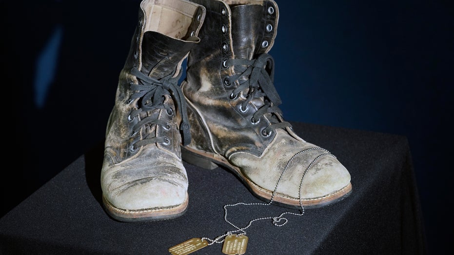 Military boots and dog tags on display