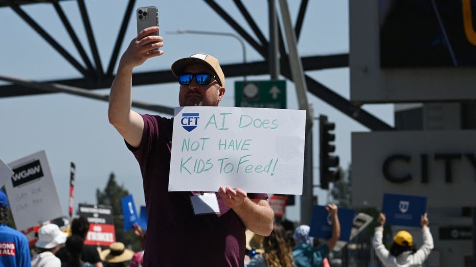 A man holds up an anti-artificial intelligence sign during the Hollywood strike