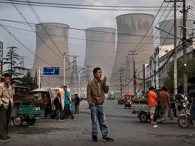 Chinese street vendors and customers gather at a local market outside a state owned Coal fired power plant near the site of a large floating solar farm project under construction by the Sungrow Power Supply Company on a lake caused by a collapsed and flooded coal mine on June 14, 2017 in Huainan, Anhui province, China. The floating solar field, billed as the largest in the world, is built on a part of the collapsed Panji No.1 coal mine that flooded over a decade ago due to over-mining, a common occurence in deep-well mining in China's coal heartland. When finished, the solar farm will be made up of more than 166,000 solar panels which convert sunlight to energy, and the site could potentially produce enough energy to power a city in Anhui province, regarded as one of the country's coal centers. Local officials say they are planning more projects like it, marking a significant shift in an area where long-term intensive coal mining has led to large areas of subsidence and environmental degradation. However, the energy transition has its challenges, primarily competitive pressure from the deeply-established coal industry that has at times led to delays in connecting solar projects to the state grid. Chinaâs government says it will spend over US $360 billion on clean energy projects by 2020 to help shift the country away from a dependence on fossil fuels, and earlier this year, Beijing canceled plans to build more than 100 coal-fired plants in a bid to ease overcapacity and limit carbon emissions. Already, China is the leading producer of solar energy, but it also remains the planetâs top emitter of greenhouse gases and accounts for about half of the worldâs total coal consumption. (Photo by Kevin Frayer/Getty Images)