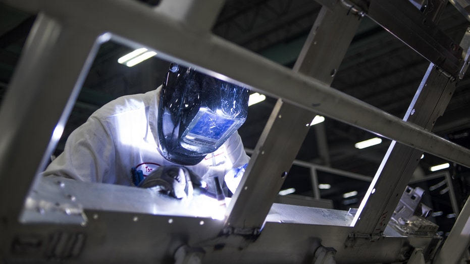 A Honda employee works at a factory