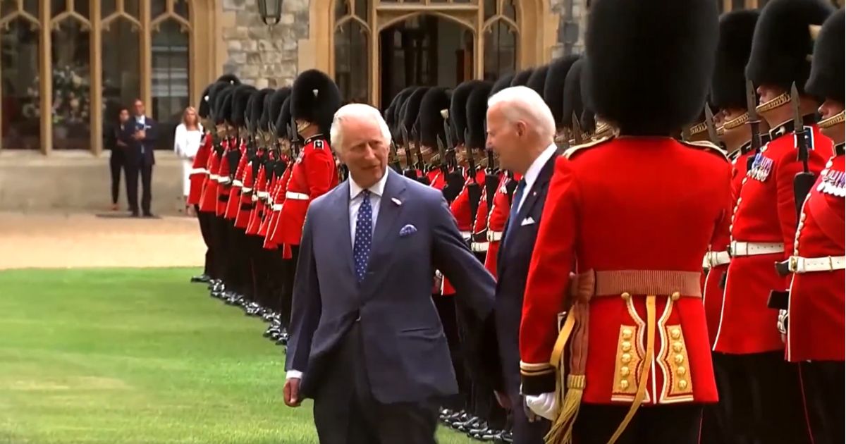 King Charles III, left, and President Joe Biden, right, inspect the Honor Guard after Biden arrives at Windsor Castle on Monday.