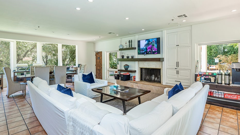 Living room with white couch and flat screen tv