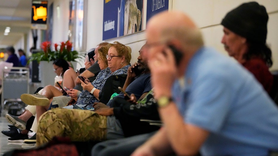 Travelers await their flights at Chicago O'Hare International airport