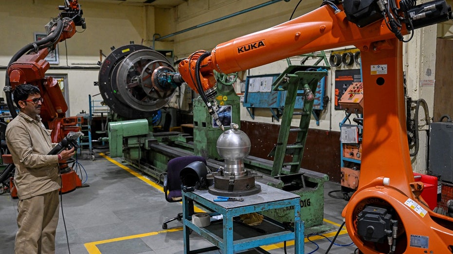 Indian engineer works at aerospace manufacturing plant