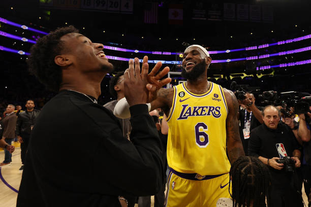 LeBron James of the Los Angeles Lakers reacts with Bronny James after scoring to pass Kareem Abdul-Jabbar to become the NBA's all-time leading...