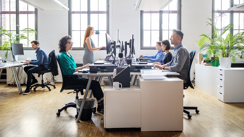 business people at desks in office