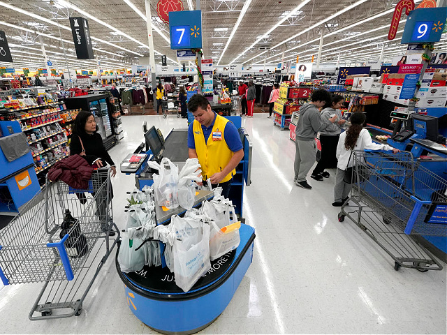 FILE- In this Friday, Nov. 9, 2018, file photo Walmart associate Luis Gutierrez, center, checks out a customer at a Walmart Supercenter in Houston. The trade dispute between the U.S. and China is weighing on the retail sector, with shares of many in the industry falling in premarket trading, Thursday, May 30, 2019. Retail shares have seesawed of late, with companies expressing concern over tariffs squeezing their businesses. (AP Photo/David J. Phillip, File)