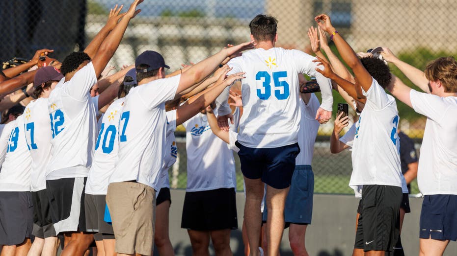 A scene from the Walmart Interns v. Executives softball game