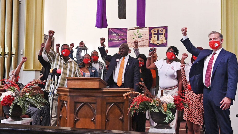 Ben Crump and Henrietta Lack's family raise their fists