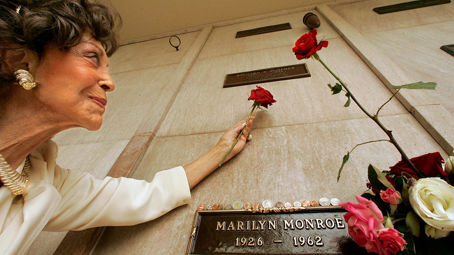 Elise Poncher looking up towards her husband's crypt