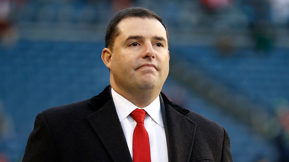 Jed York looks on field