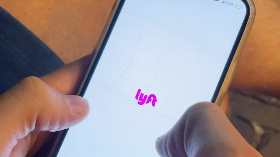 A person holds the lyft app up on their phone