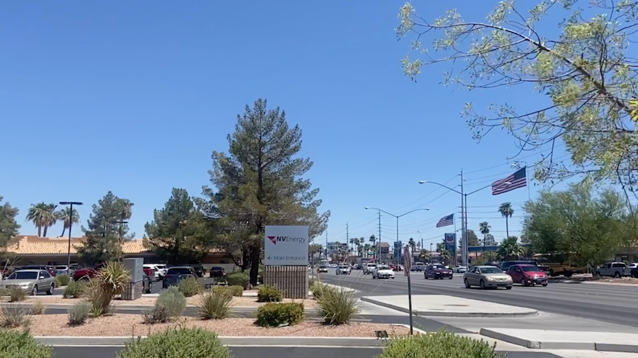 Cars on the road driving by a Nevada Energy sign.