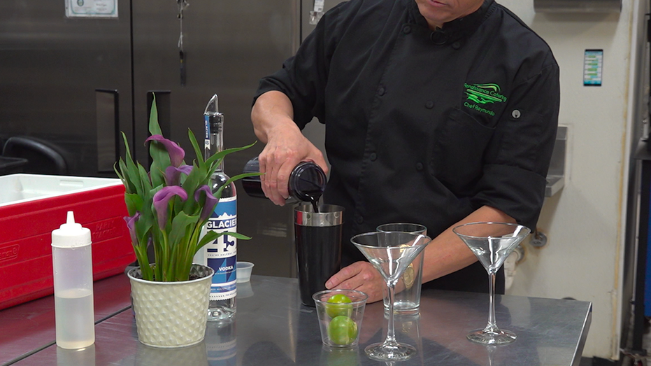 A man pouring a liquid into a cup.