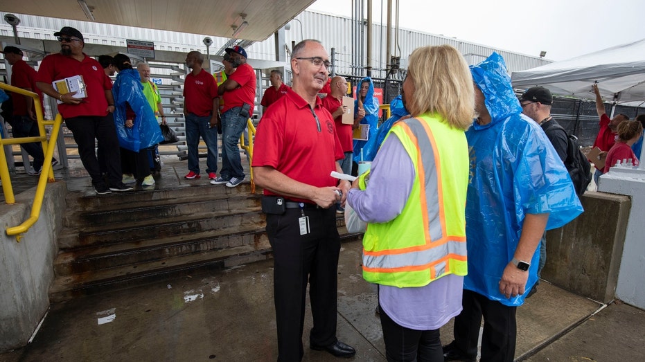 United Auto Workers (UAW) President Shawn Fain speaks with workers