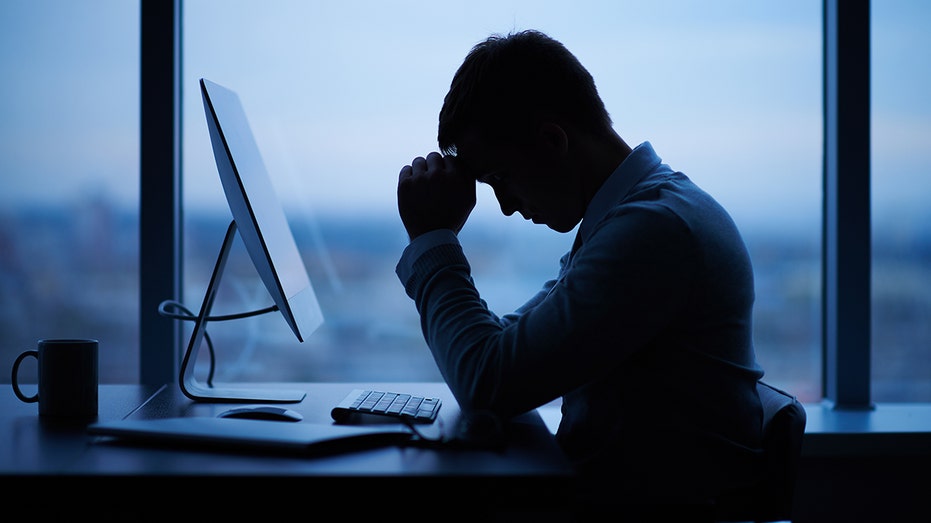 tired or stressed businessman in office