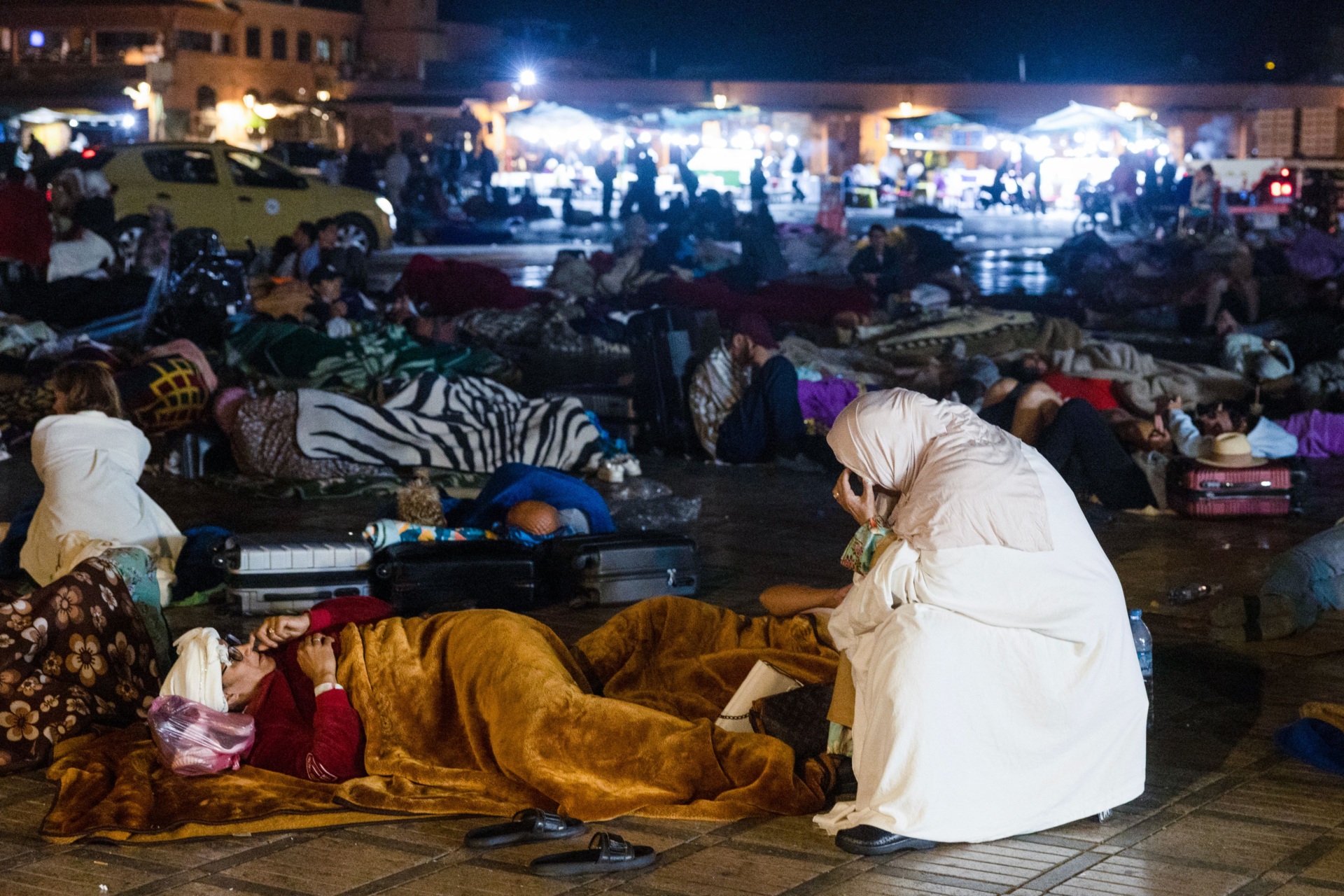 TOPSHOT - Residents stay out at a square in Marrakesh on September 9, 2023, after an earthquake. A powerful earthquake that struck Morocco on September 8 night has killed at least 632 people and injured 329 others, according to an updated interior ministry toll. (Photo by FADEL SENNA / AFP) (Photo by FADEL SENNA/AFP via Getty Images)