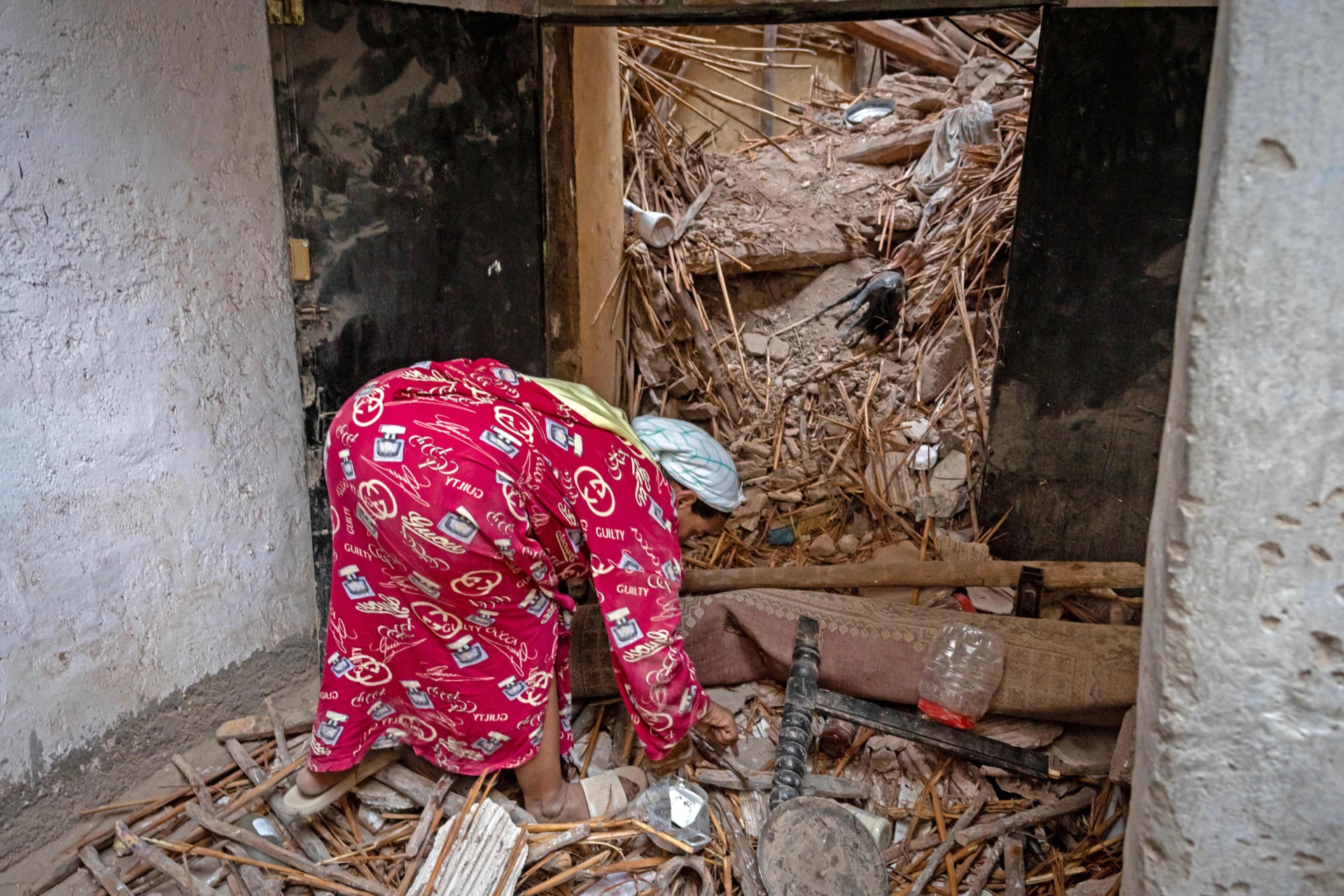 TOPSHOT - A woman inspects the damage following a 6.8-magnitude quake in Marrakesh on September 9, 2023. A powerful earthquake that shook Morocco late September 8 killed more than 600 people, interior ministry figures showed, sending terrified residents fleeing their homes in the middle of the night. (Photo by FADEL SENNA / AFP) (Photo by FADEL SENNA/AFP via Getty Images)