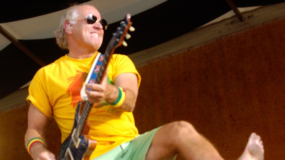 Jimmy Buffett playing the guitar