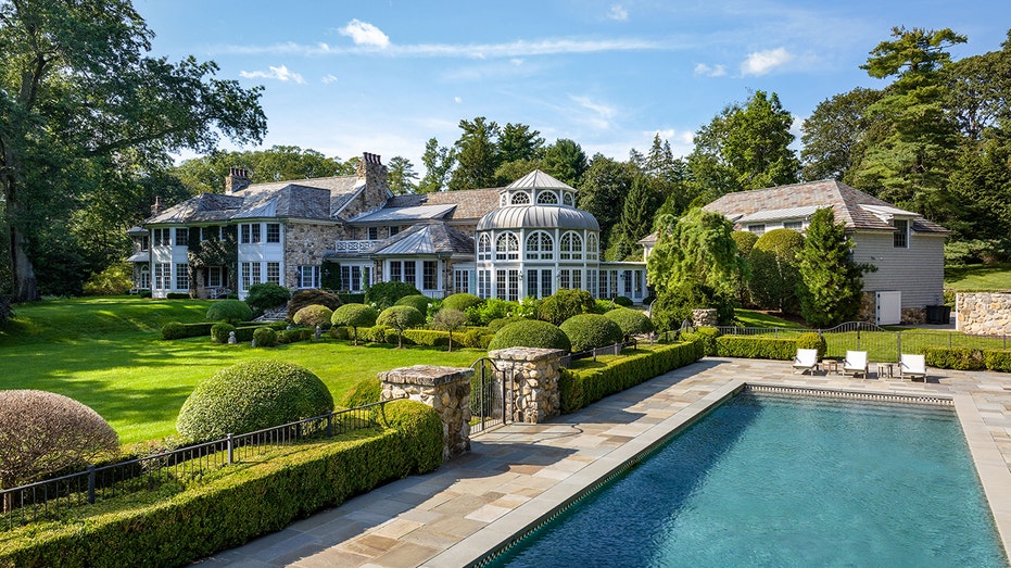 swimming pool with house in background