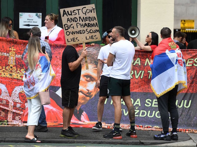 People hold placards up at a government detention centre where Serbia's tennis champion Novak Djokovic is reported to be staying in Melbourne on January 7, 2022, after Australia said it had cancelled the entry visa of Djokovic, opening the way to his detention and deportation in a dramatic reversal for the tennis world number one. (Photo by William WEST / AFP) (Photo by WILLIAM WEST/AFP via Getty Images)