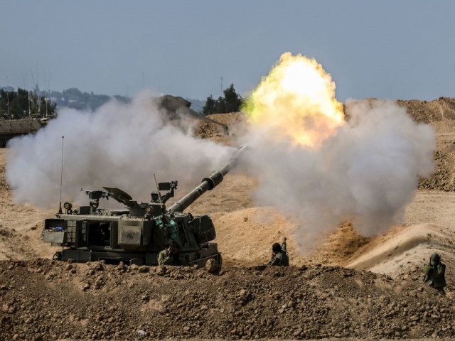 Graphic content / Israeli artillery unit fire towards the Gaza Strip in southern Israel on October 13, 2023, as battles between Israel and the Palestinian Hamas movement continue for the seveth consecutive day. Thousands of people, both Israeli and Palestinians have died since October 7, 2023, after Palestinian Hamas militants entered Israel in a surprise attack leading Israel to declare war on Hamas in the Gaza Strip enclave on October 8. (Photo by Aris MESSINIS / AFP) (Photo by ARIS MESSINIS/AFP via Getty Images)