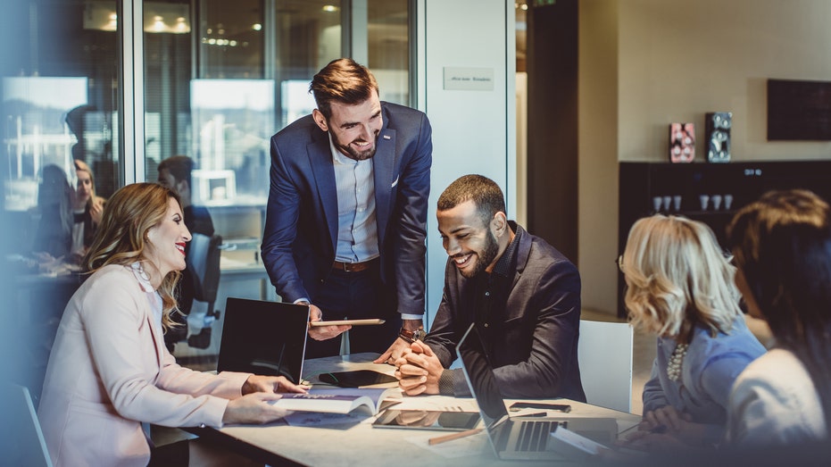 Colleagues working in office together