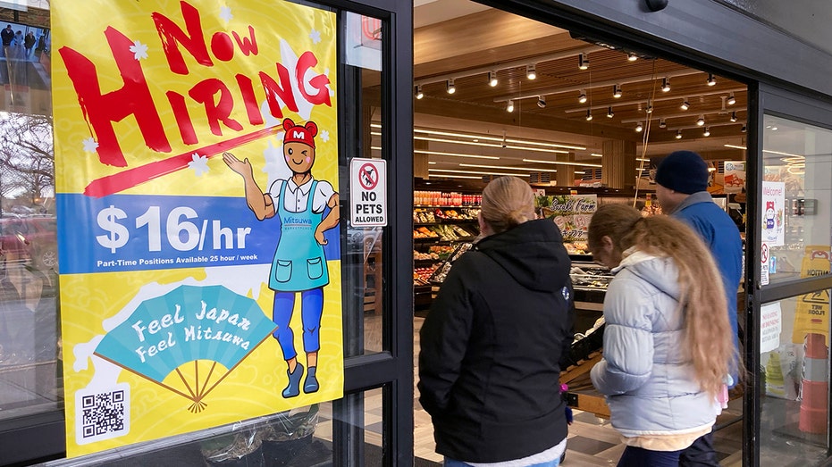 Hiring sign is displayed at a grocery store