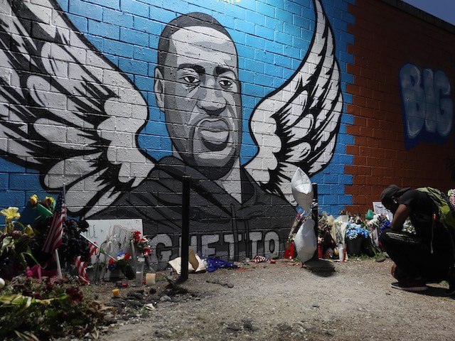 Joshua Broussard kneels in front of a memorial and mural that honors George Floyd at the Scott Food Mart corner store in Houston's Third Ward where Mr. Floyd grew up on June 8, 2020 in Houston, Texas. The funeral and burial for George Floyd will be held June 9. Floyd died on May 25th while in Minneapolis police custody, sparking nationwide protests. (Joe Raedle/Getty Images)