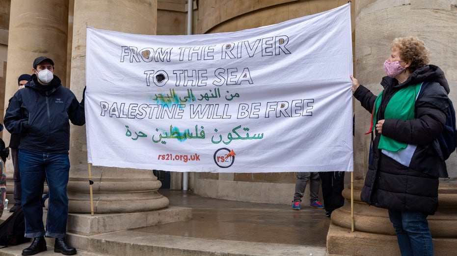 pro-Palestinian demonstrators unfurl sign