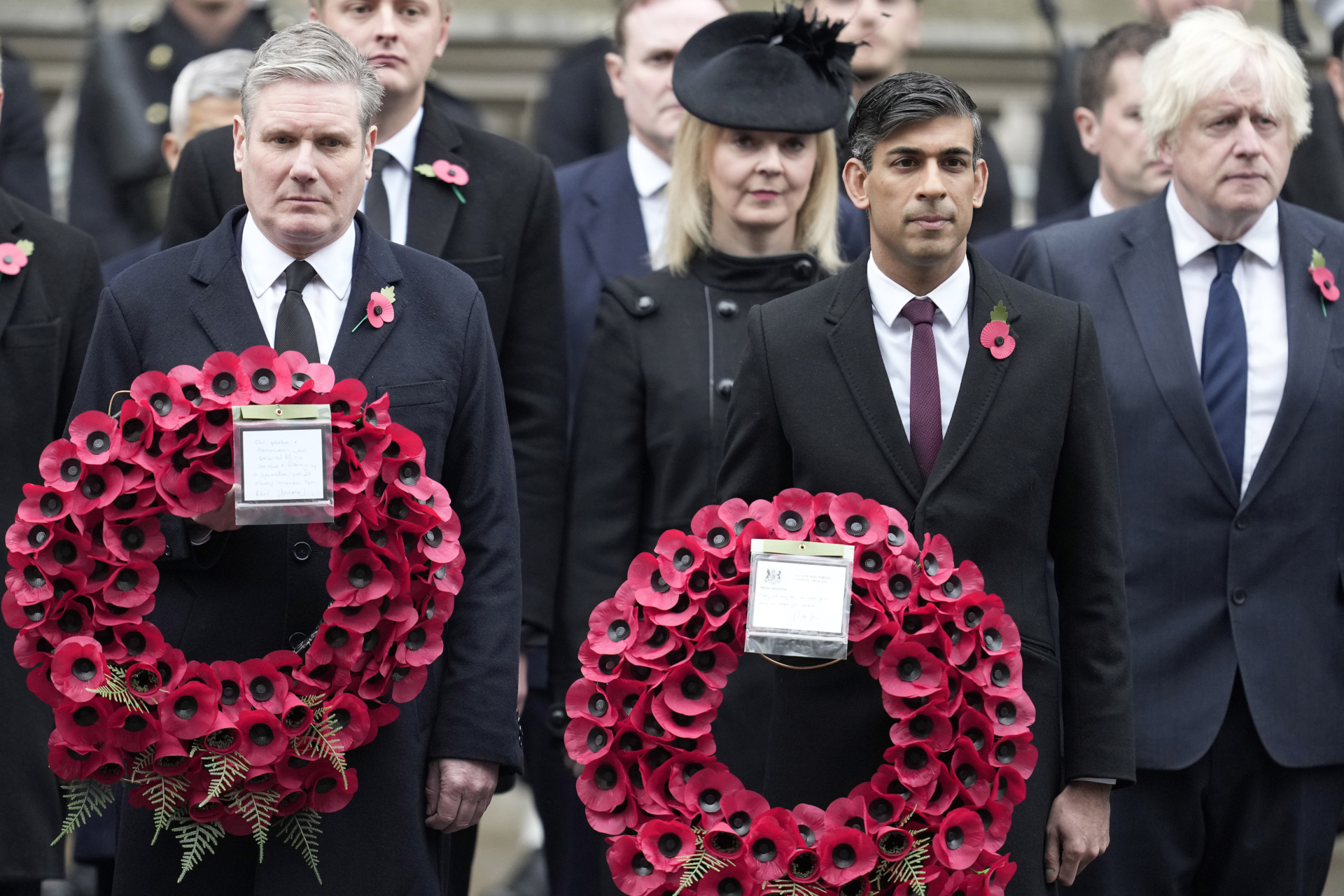 LONDON, ENGLAND - NOVEMBER 12: Prime Minister Rishi Sunak, second right, holds a wreath as he stands with Labour Party leader Keir Starmer, left, former Prime Ministers Liz Truss, third right, and Boris Johnson, right, to attend the Remembrance Sunday ceremony at the Cenotaph on November 12, 2023 in London, England. Every year, members of the British Royal family join politicians, veterans and members of the public to remember those who have died in combat. (Photo by Kin Cheung - WPA Pool/Getty Images)