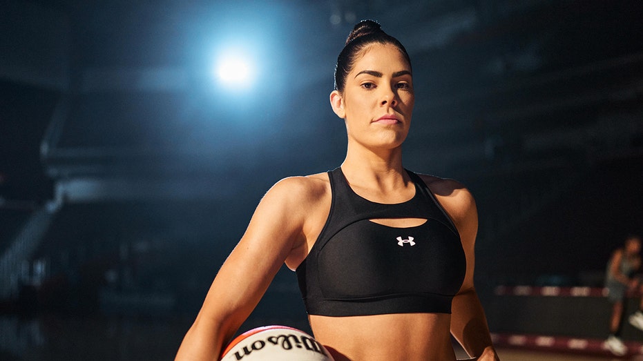 Kelsey Plum poses with basketball in hand