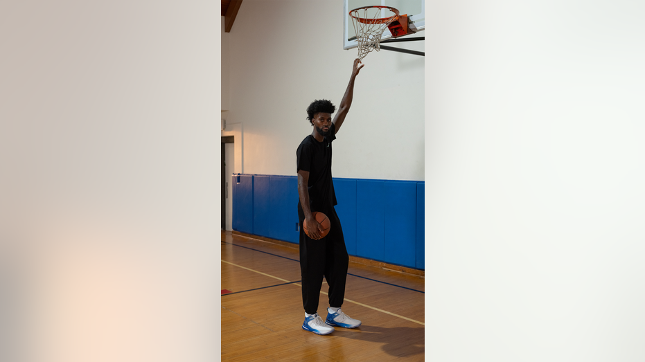 very tall man in blue and white sneaker