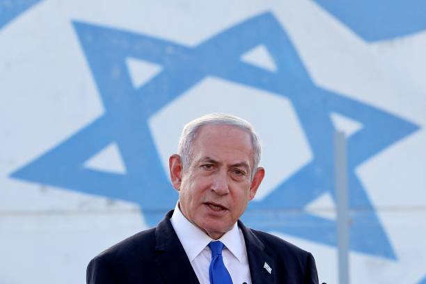 Israel's Prime Minister Benjamin Netanyahu delivers a speech during his visit to an Israeli unmanned aerial vehicle centre, at the Palmachim Airbase...