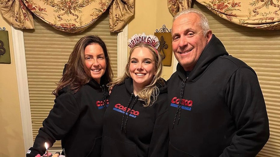 Madison with parents in Costco sweatshirts