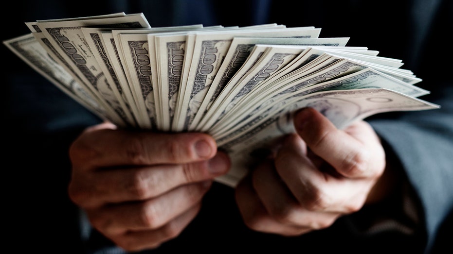 File photo of a man holding cash