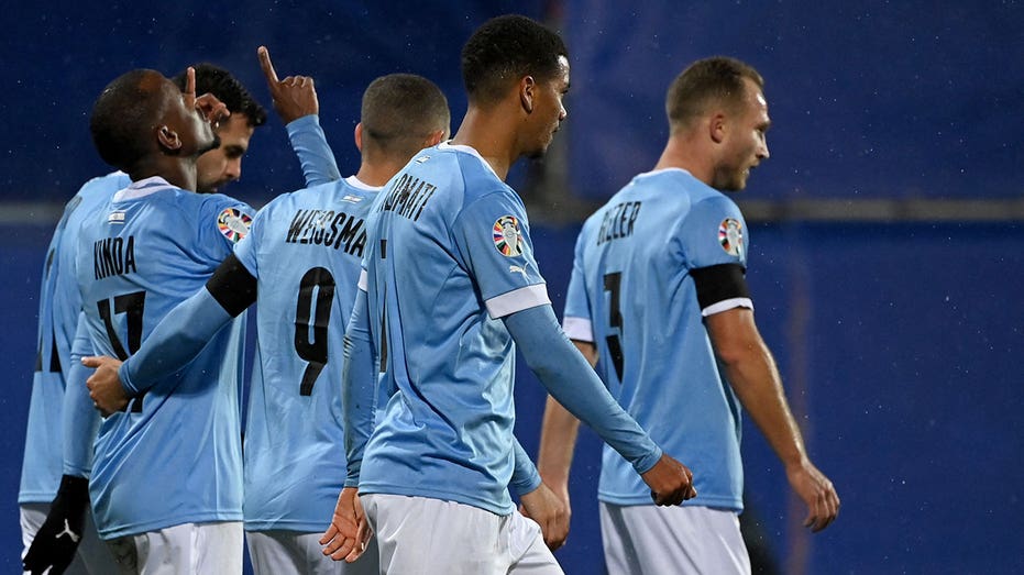 Israeli football players celebrate after goal