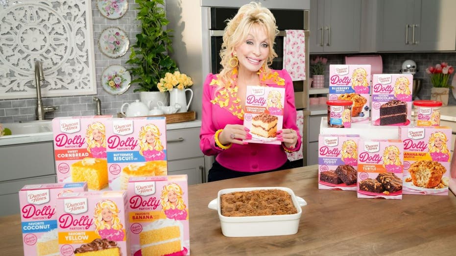 Dolly Parton holding baking mixes