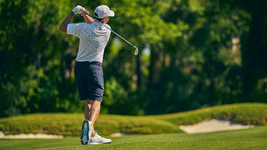 Golfer finishes swing