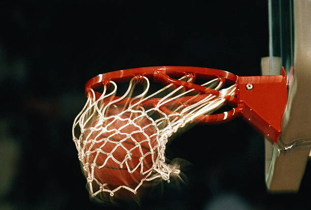 basketball, ball going through hoop, close-up (blurred motion) - basketball hoop stock pictures, royalty-free photos & images