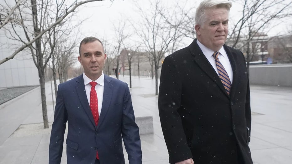 Jonathan Dunn walks with his lawyer after their court apperance