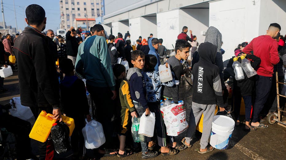 Palestinians wait in line for water in Gaza