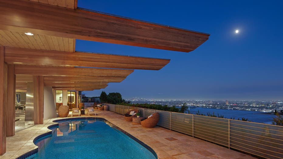 night view of pool and deck